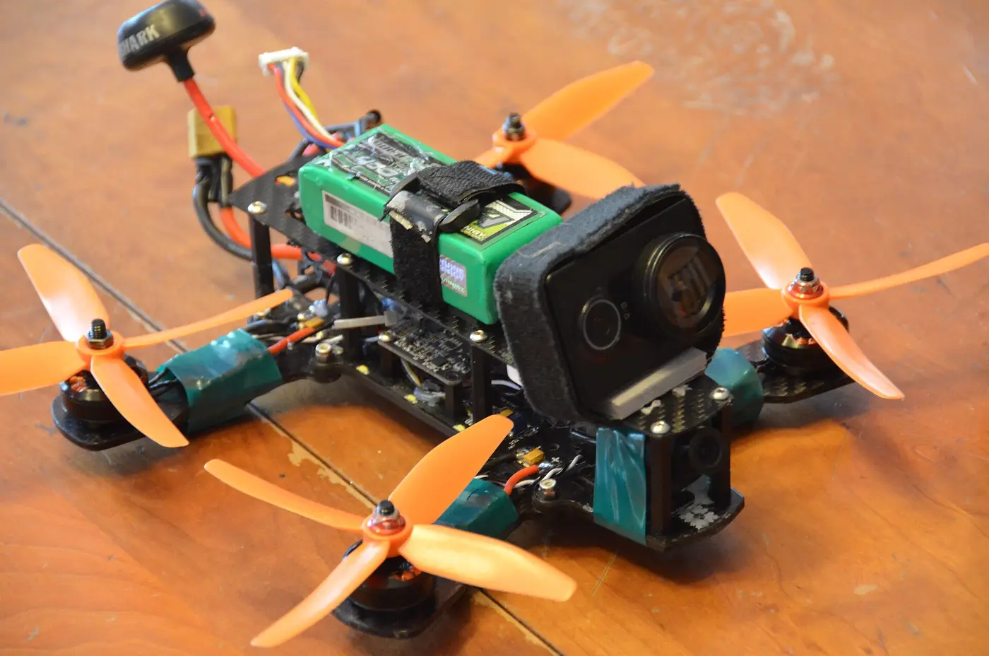A hand-built FPV drone showing its frame, motors, propellers and camera